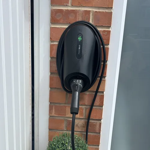 Tethered EV charger fitted beside a front door, the kind of driveway charger our electrician in Harborne installs