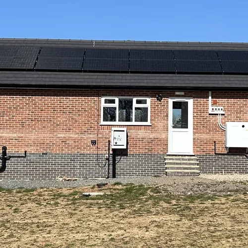 Full-length solar PV array across a bungalow roof