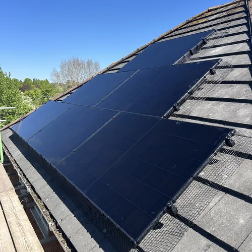 Solar panel array on a pitched roof, the kind of system our electrician in Bournville plans subject to Trust consent