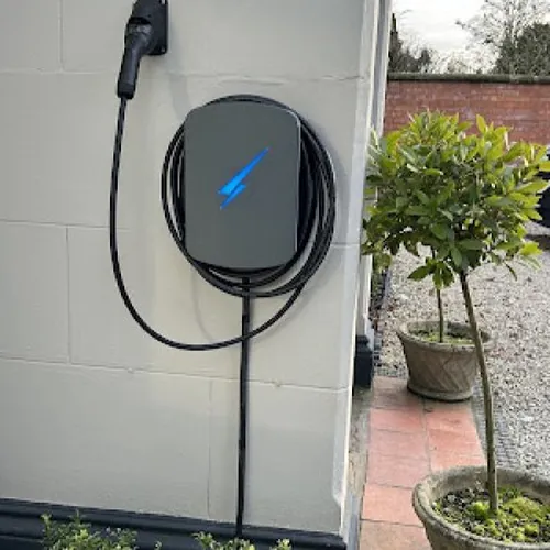 Tethered smart EV charger fitted beside a gravel driveway